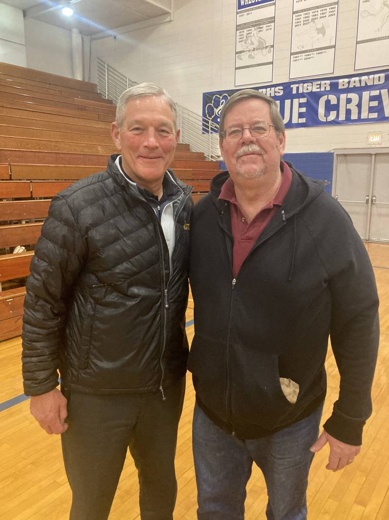 Iowa Hawkeye football coach Kirk Ferentz visits with BCR Sports Editor Kevin Hieronymus atTuesday's Princeton basketball game.