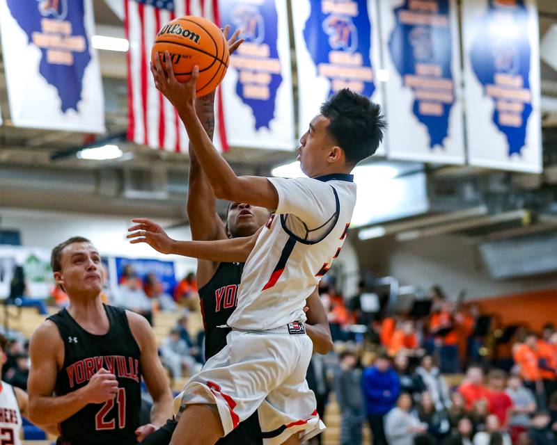 Oswego's Ethan Vahl (3) goes in for a layup during their basketball game between Yorkville at Oswego, Tuesday Dec 10, 2024 in Oswego.