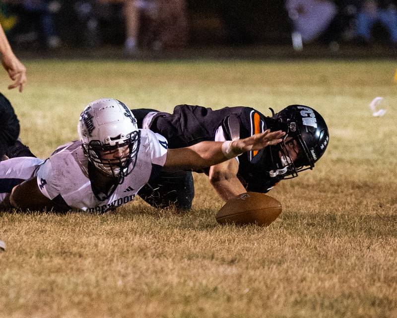 Rob Sandberg (4) of Ridgewood reaches for flying mouth guard whilst fighting with Leelynd Durbin (7) of FCW on floor over possession of loose ball on Friday, Sept. 26, 2025, at Woodland School in rural Streator.