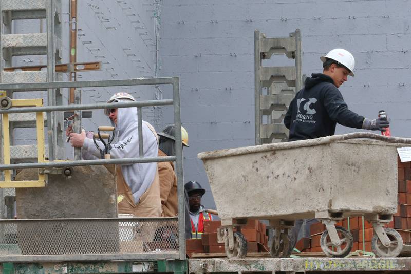 Workers lay bricks and prepare the exterior walls of the La Salle-Peru Township High School's new Agriculture Center on the southeast corner of Sixth and Creve Coeur streets on Wednesday, April 1, 2026 in La Salle.