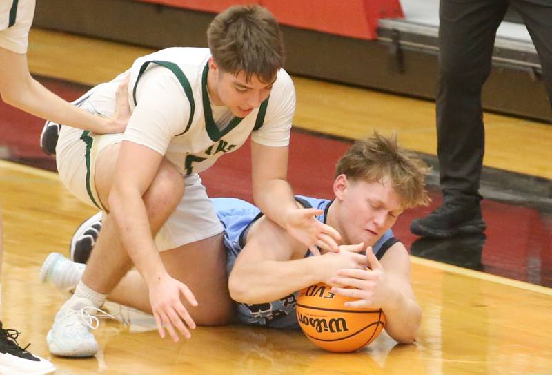 Bureau Valley's Elijah Endress covers up the ball as St. Bede's Halden Hueneburg forces a jump during the 50th annual Colmone Classic on Thursday, Dec. 12, 2024 at Hall High School.