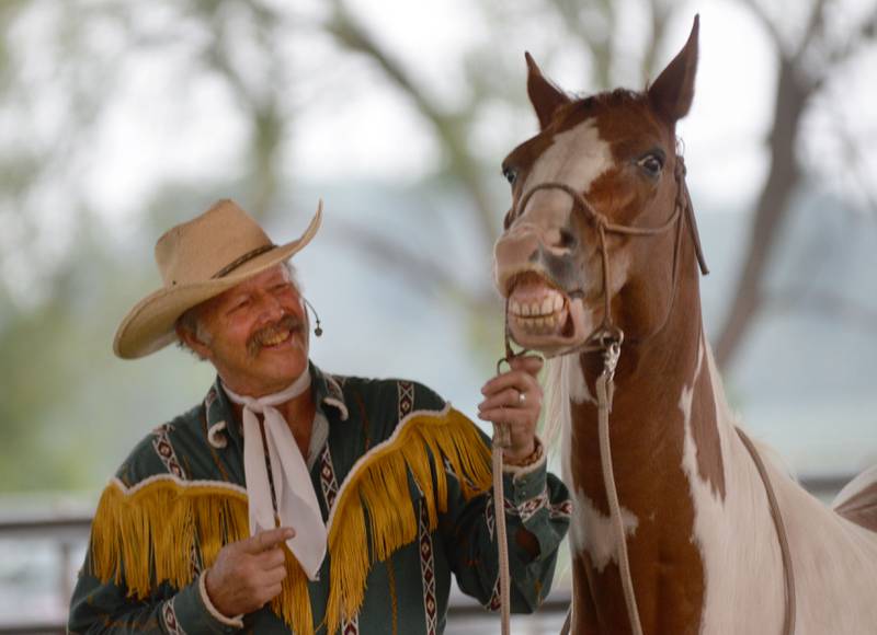 The Rhinestone Roper's horse, Gypsy Rose, laughs at one of his jokes during a performance at the Ogle County Fair in Oregon on Thursday, July 31, 2025.
