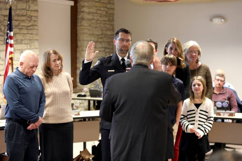 Eric Blowers, surrounded by his family, is sworn in as Batavia Police Chief on Monday, Jan. 6, 2025 by Batavia Mayor Jeffery Schielke during a city council meeting.