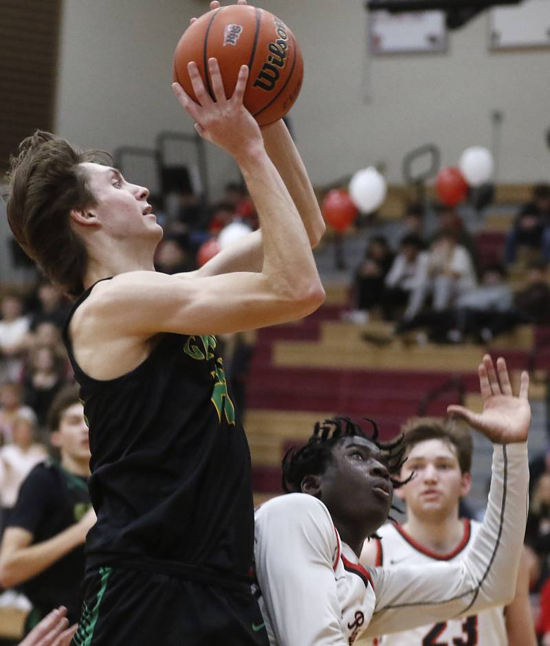 Crystal Lake South's James Carlson drives to the basket against Huntley's Sheldon Bonsu during a Fox Valley Conference boys basketball game Tuesday, Feb.6, 2024, at Huntley High School.
