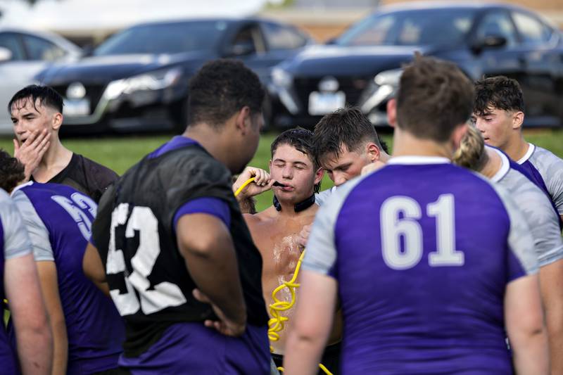 Dixon footballer Jake Zepezauer grabs a drink Monday, August 11, 2025, for the first day of football practice.