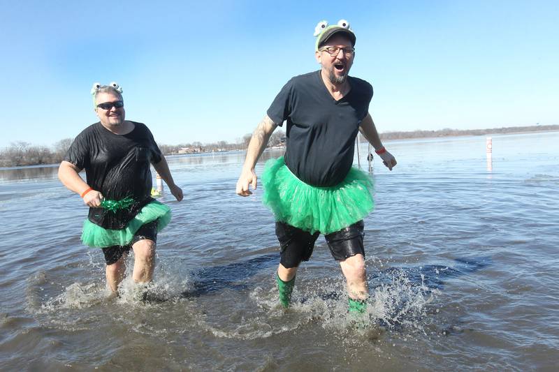 Eric Fowler and Rob Zando, both of Spring Grove, take the plunge in frigid Nippersink Lake during the Special Olympics Polar Plunge on Feb. 26 at Lakefront Park in Fox Lake.
