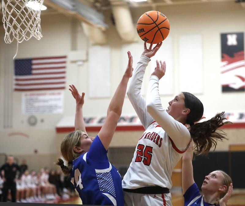 Huntley's Evie Freundt drives to the basket against Burlington Central's Ali Kowal during a Fox Valley Conference girls basketball game on Tuesday Jan. 13, 2026, at Huntley High School.