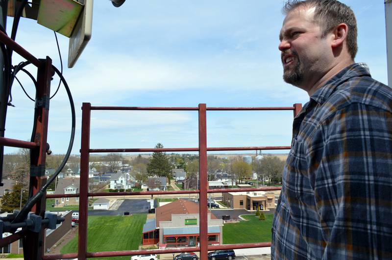 John Russell, of rural Mt. Morris, admires the view from the attic-level fire escape of the former Kable News Company building on the Mt. Morris campus on April 20, 2023. Russell closed on the purchase of the building on March 1; he plans to restore and modify it into multi-use space that benefits the community.