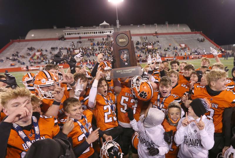 Members of the Byron football team hoist the Class 3A state championship trophy after defeating Mt. Carmel in the Class 3A State football championship on Friday, Nov, 24, 2023 at Hancock Stadium in Normal.