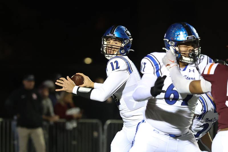 St. Charles North's J.T. Padron looks to pass against Brother Rice in the third round of the playoffs on Saturday, Nov. 15, 2025 in Chicago.