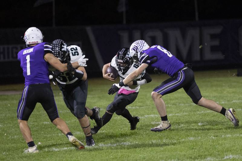 Woodstock North’s Michael Pintor is tackled by Dixon’s Bene Baratta Friday, Oct. 31, 2025, in the Class 4A football first round playoffs.