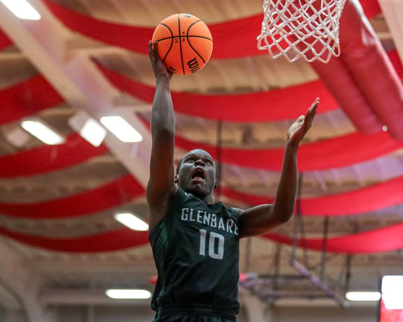 Glenbard West's Josh Abushanab (10) puts in a layup off of a drive during their basketball game between Glenbard West at Hinsdale Central, Friday  Dec 6, 2024  in Hinsdale.