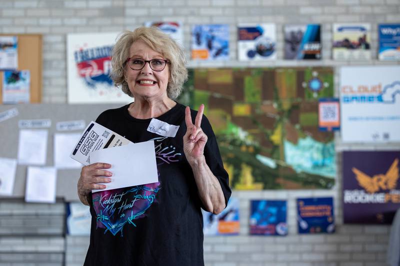 Kathy Traegar holds up 2 fingers after raising $2,000+ at “Kathy’s BIG LEAP for a BIG CAUSE” on Friday, July 11, 2025 at Skydive Chicago in Ottawa.