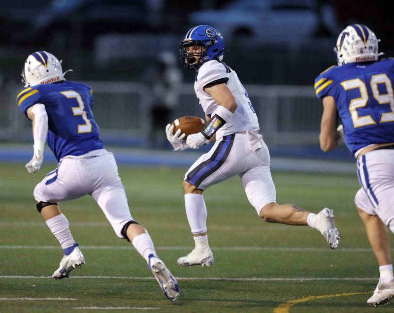 Brian Hill/bhill@dailyherald.com
Lake Zurich's Tyler Erkman (5) looks back on his way to a touchdown against Wheaton North during the second round of the IHSA playoffs Saturday November 5, 2022 in Wheaton.