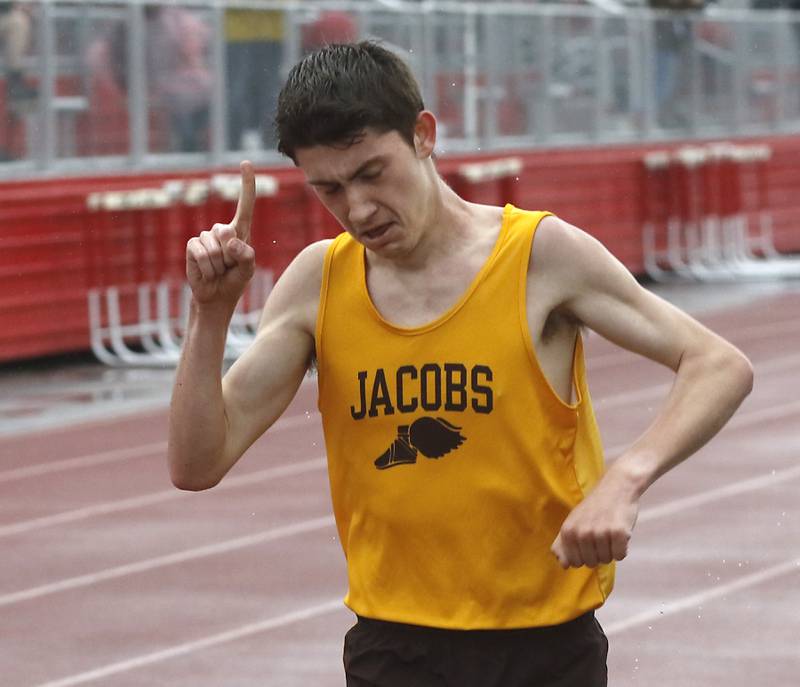 Jacobs’ Aidan DeMuth celebrates winning the 3200 meter run Friday, May 12, 2023, during the Fox Valley Conference Boys Track and Field Meet at Huntley High School.
