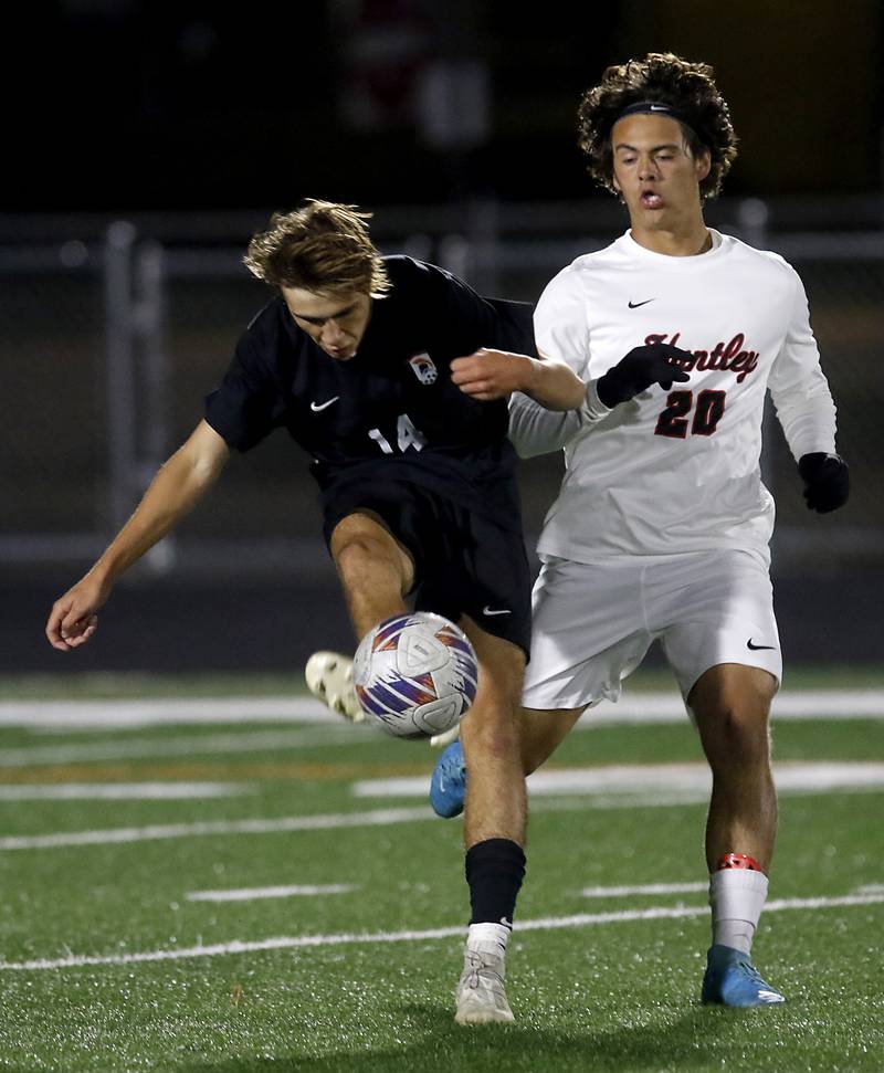 McHenry's Kyren Rivard kicks the ball away from Huntley's Joe Lengle during a Fox Valley Conference boys soccer match on Thursday, Oct. 9, 2025, at McCracken Field in McHenry.