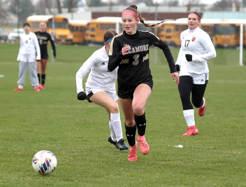 Sycamore's Marin Gautcher gets by a pair of La Salle-Peru defenders during their game Wednesday, April 9, 2025, at Sycamore High School.