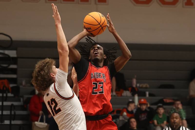 Bolingbrook’s Kendall Cutler takes a contested shot against Minooka on Tuesday, Dec. 17, 2024 in Minooka.