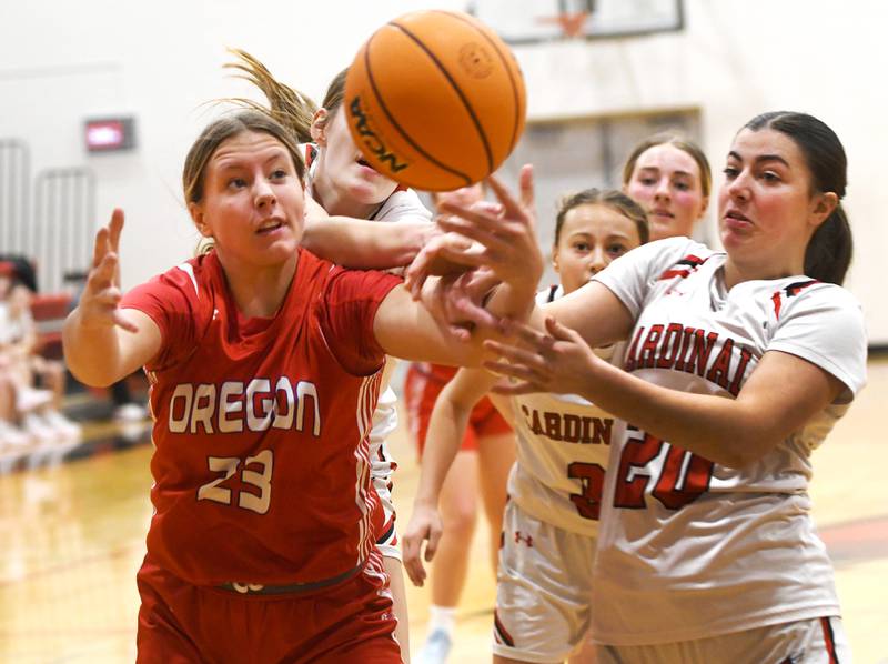 Oregon's Aniyah Sarver (23) and Forreston's Madalyn Thiel (20) reach for the ball during a Saturday, Jan. 3, 2026 game at Forreston High School.
