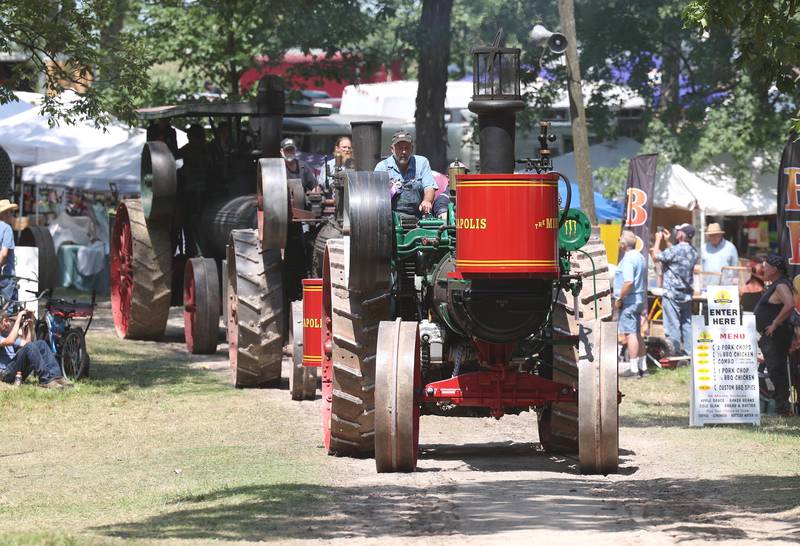 Steam powered tractors make their down the parade route Thursday, Aug. 8, 2024, during the 67th annual Sycamore Steam Show and Threshing Bee at Taylor Marshall Farm.