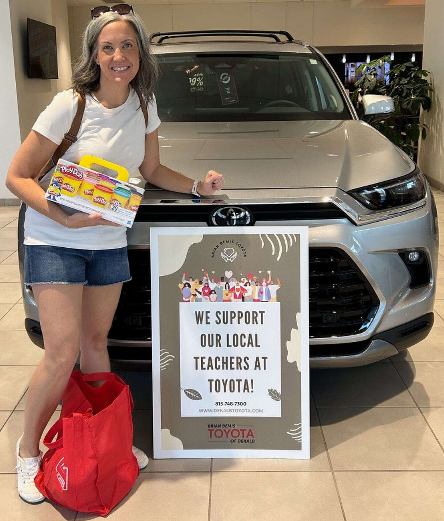 DeKalb school teacher receiving Brian Bemis Toyota of DeKalb school supplies donation