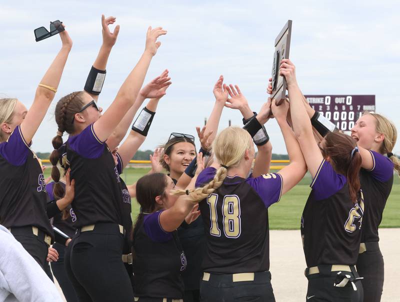 Members of the Serena softball team hoist the Class 1A Regional plaque after defeating Marquette 2-1 on Friday, May 22, 2026 at Serena High School.
