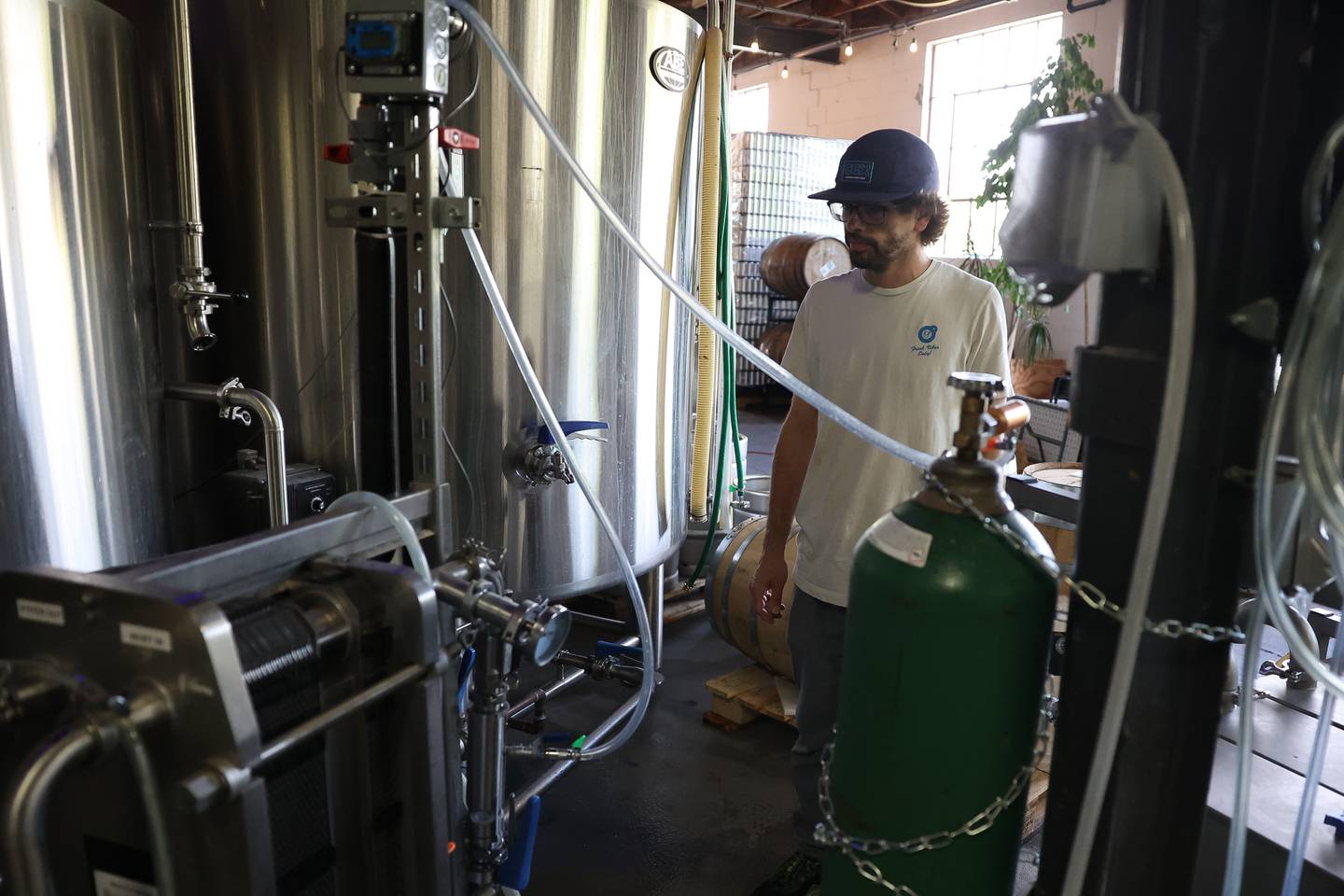 Werk Force Brewery Head Brewer Jacob Scheufler check on a batch of beer on Friday, Sept. 29, 2023 in Plainfield.