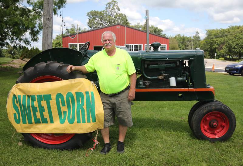 Rob Wessels, owner of Wessels’ Family Farm, with his tractor Thursday, July, 18, 2024, at the market in DeKalb.