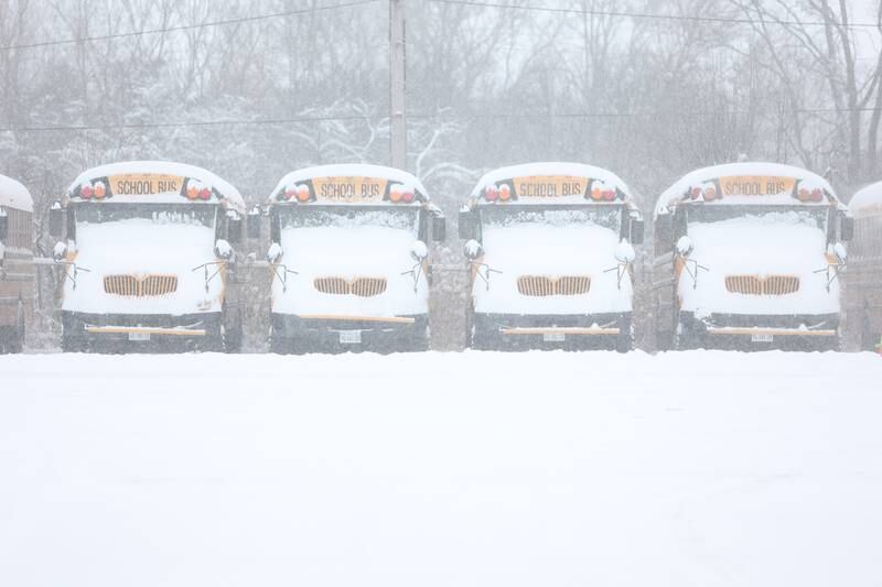 Snow covered buses sit in the lot of Firstgroup America as schools closed due to the winter storm. Wednesday, Feb. 2, 2022 in Joliet.