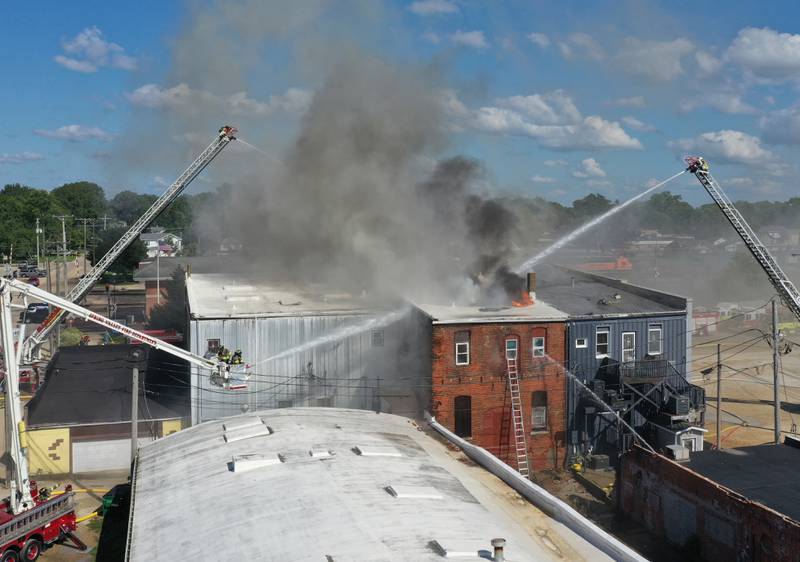 Flames and smoke can be seen from a building in 800 block of Main Street on Monday, Aug. 22, 2022 in Mendota.