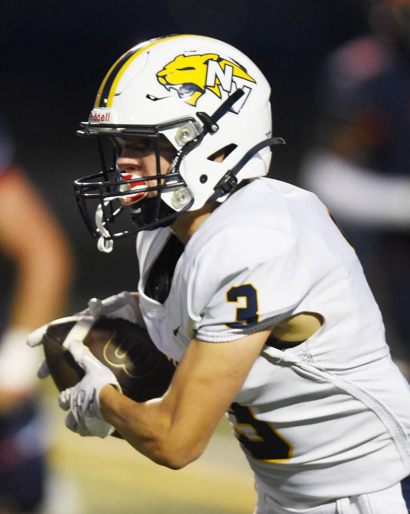Joe Lewnard/jlewnard@dailyherald.com
Neuqua Valley’s Carter Stare carries the ball after catching a pass during Friday’s game at Naperville North.