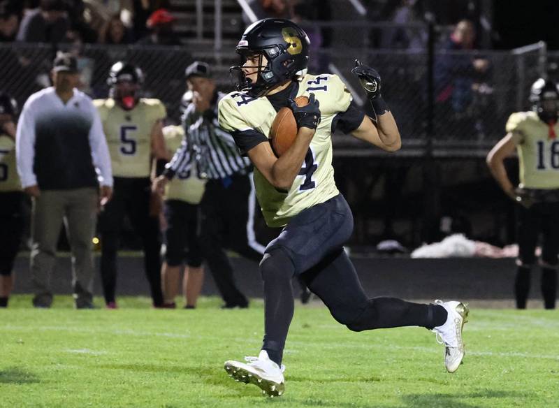 Sycamore's Josiah Mitchell breaks free for a touchdown after a catch in the Ottawa secondary during their game Friday, Sept. 27, 2024, at Sycamore High School.