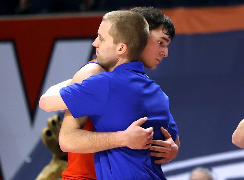 Eastland's head coach Tyler Zumdahl hugs his players as the final seconds tick off in their IHSA Class 1A state championship loss to Chicago Hope Academy Saturday, March 15, 2025, in the State Farm Center at the University of Illinois in Champaign.