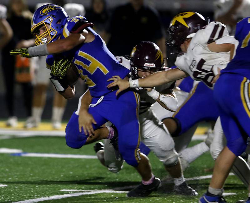 Johnsburg's Duke Mays tries to get out of the grasp of Richmond-Burton's Gavin Busa during a Kishwaukee River Conference football game on Friday, Sept. 12, 2025, at Johnsburg High School.