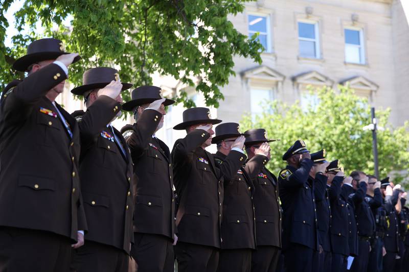 Members of local police departments salute for the national anthem during the Kankakee County Law Enforcement Memorial on Thursday, May 14, 2026, at the Kankakee County Courthouse.