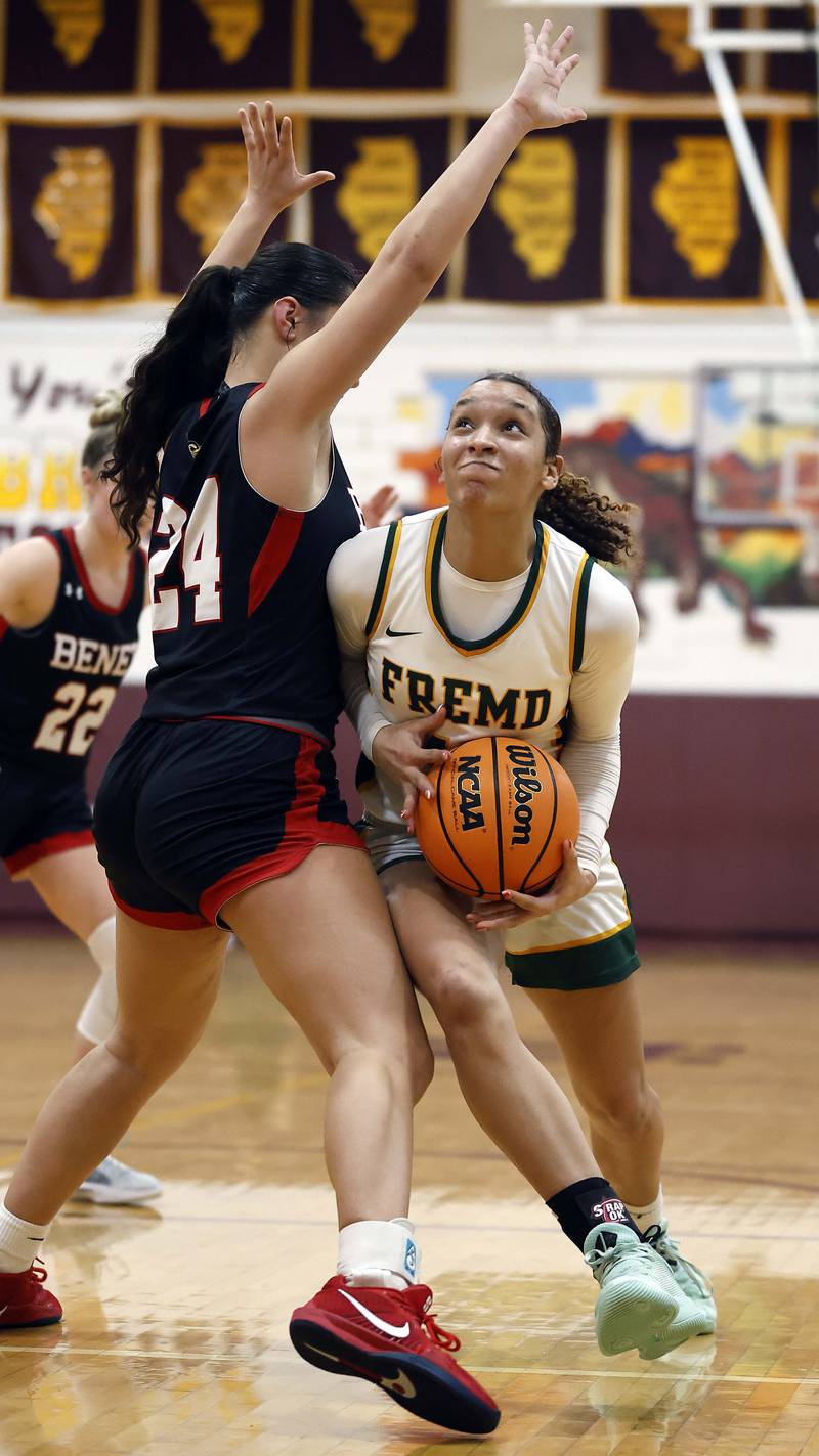 Fremd’s Coco Urlacher (11) scoots around Benet Academy's Emma Briggs (24) on her way to the hoop during the Montini girls basketball Christmas tournament Saturday, Dec. 28, 2024 in Lombard.