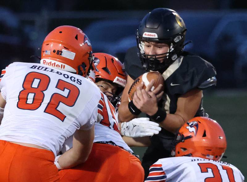Sycamore's Griffin Larsen runs into a pack of Mahomet-Seymour defenders during their game Friday, Sept. 12, 2025, at Sycamore High School.