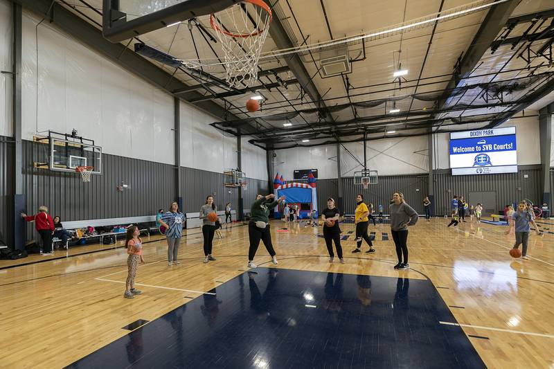 Teachers and staff from St. Anne’s School get into a spirited game of P-I-G Tuesday, Jan. 31, 2023 at The Facility in Dixon.