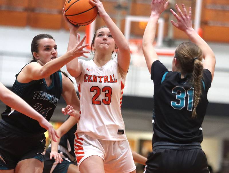 Crystal Lake Central’s Jordyn Johnson navigates heavy Woodstock North traffic under the net in varsity girls basketball on Monday, Jan. 26, 2026, at Crystal Lake Central High School in Crystal Lake.