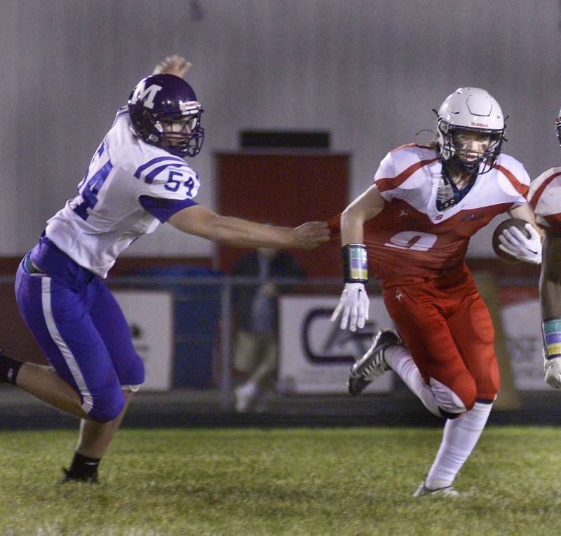 Manreno’s Cooper Monk grabs and works to stop Streator’s Jake Haigie on a run in the 2nd quarter Friday at Streator.