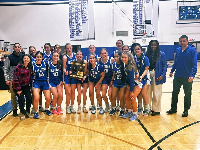 The Wheaton North girls basketball team celebrates after beating St. Charles North to win the Class 4A St. Charles North Regional.