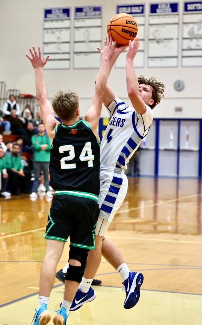 Princeton's Julian Mucha shoots over Rock Falls' Owen Mandrell in Tuesday's game at Prouty Gym. The Rockets won 61-58.