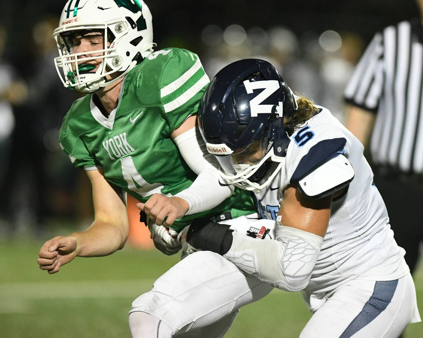 Nazareth Academy’s Gabe Kaminski (5) tries to tackle York’s QB Sean Winton before getting a pass off during the second quarter on Friday Sep. 1, 2023, in Elmhurst.
