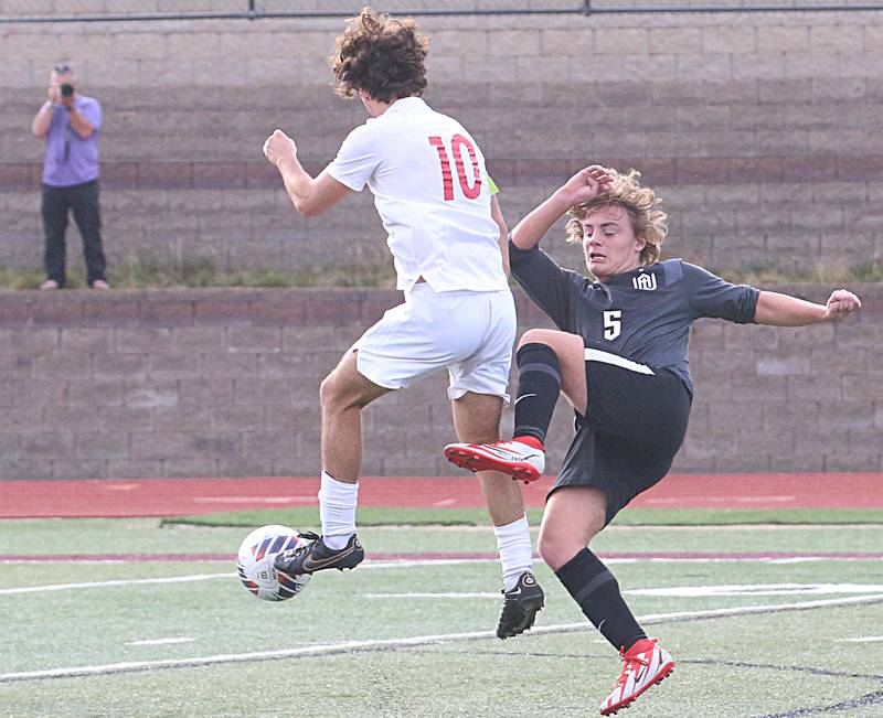 Timothy Christian's Cameron Baker (10) kicks the ball past Wheaton Academy's Scotty Murray (5) during the Class 1A State soccer third place game on Saturday, Oct. 29, 2022 at EastSide Centre in Peoria.