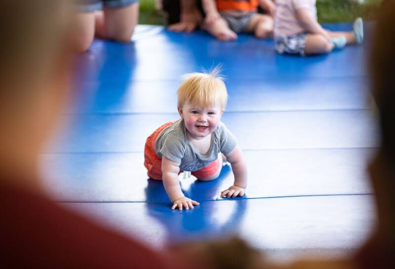 Benjamin Reinhardt, 11 months, crawls to the finish line during the Diaper Derby at the Batavia Windmill City Fest in Batavia on Sunday, July 9, 2023.