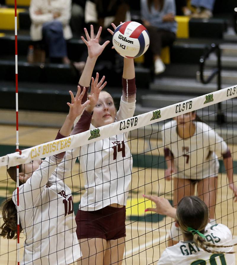 Prairie Ridge's Addison Smith and Jada Hoyt block the hit of Crystal Lake South's Morgan Johnson during the IHSA Class 3A Crystal Lake South Sectional final volleyball match on Thursday, Nov. 7, 2024, at Crystal Lake South High School.