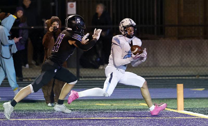 Prospect's Nathan Cichy (6) reels in a long touchdown pass over Downers Grove North's Connor Crowley (21) during the IHSA Class 7A playoff football game Friday, Oct. 31, 2025 in Downers Grove.