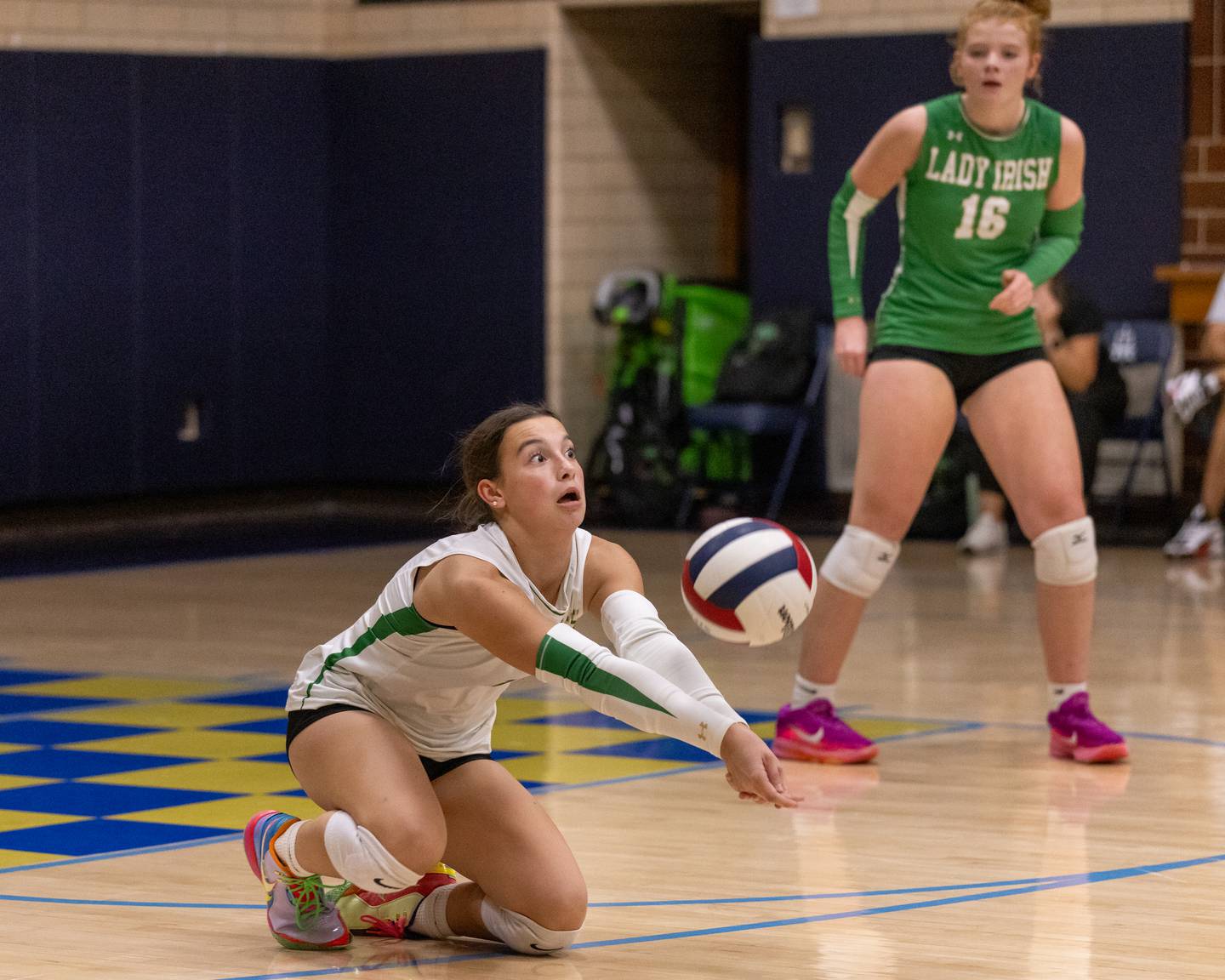 Seneca High School's Libero Tori Skelton slides to make a diving save against Marquette at Bader Gym on September 25, 2025 at Marquette High School.