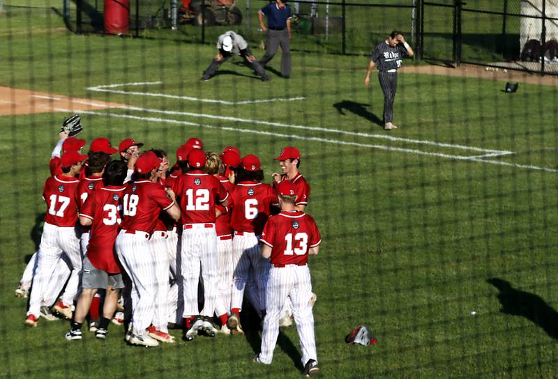 Prairie Ridge's Conner Pollasky walks off the field as Deerfield players celebrate their 1one run win over Prairie Ridge in a Class 3A Deerfield baseball regional game Wednesday, May 22, 2024, at the Deerfield High School.
