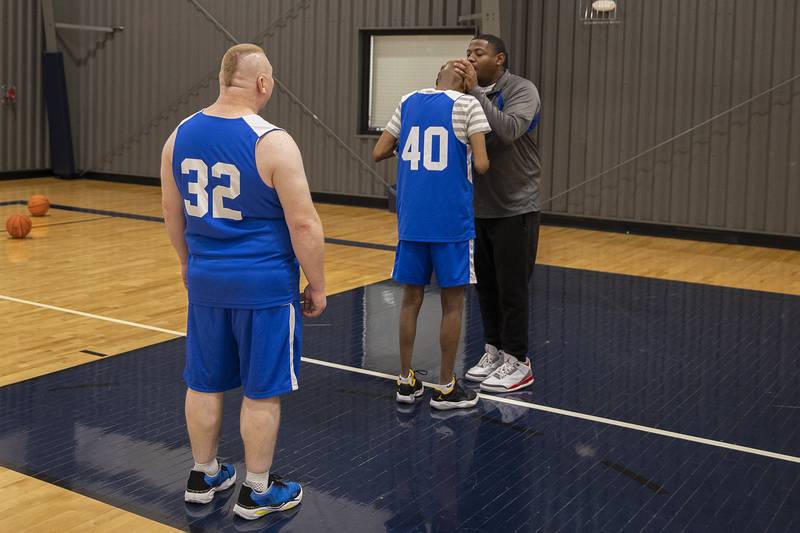 Coach Townsend kisses Tim’s head for good luck Wednesday, Dec. 18, 2024, during practice.